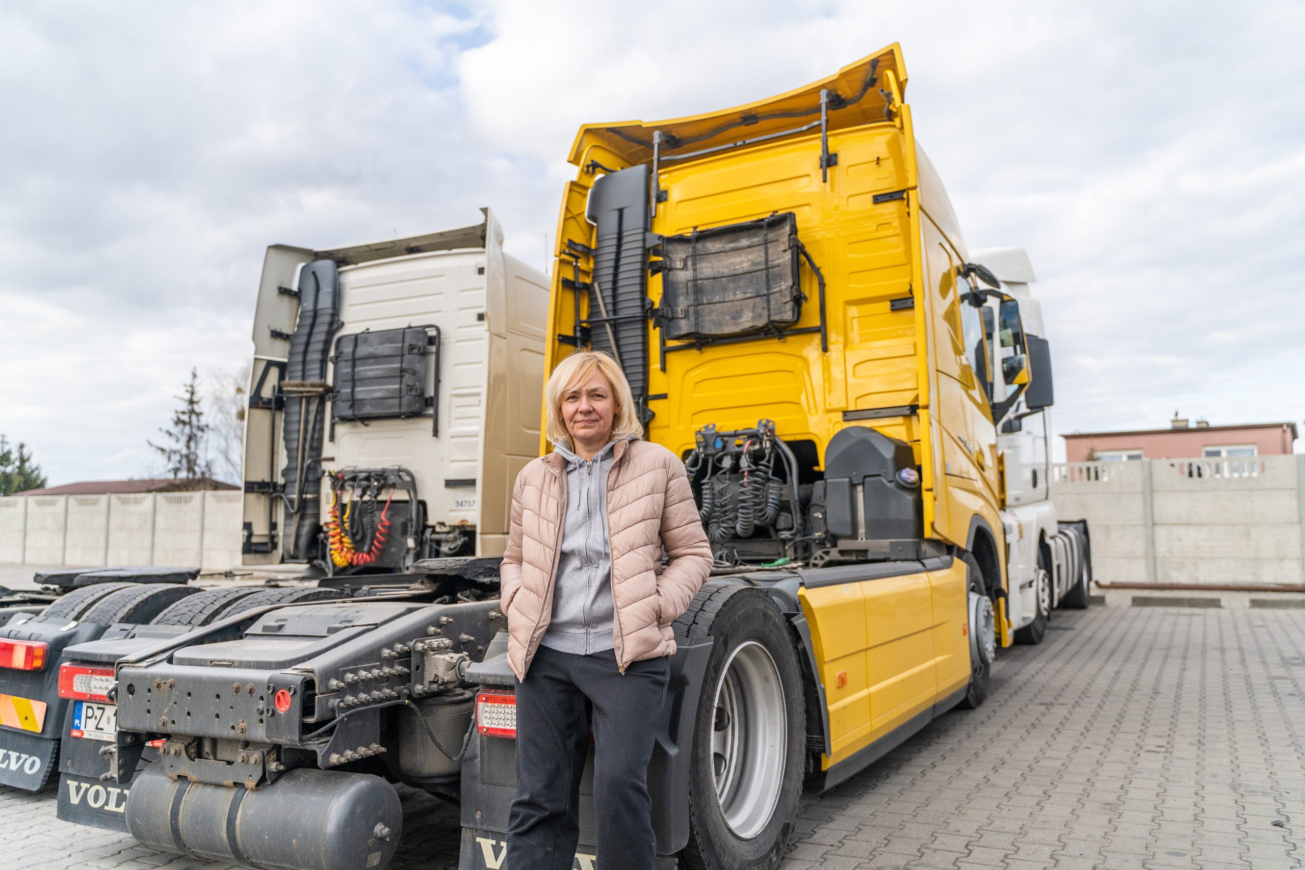 caucasian mid age woman driving truck. trucker female worker, transport industry occupation