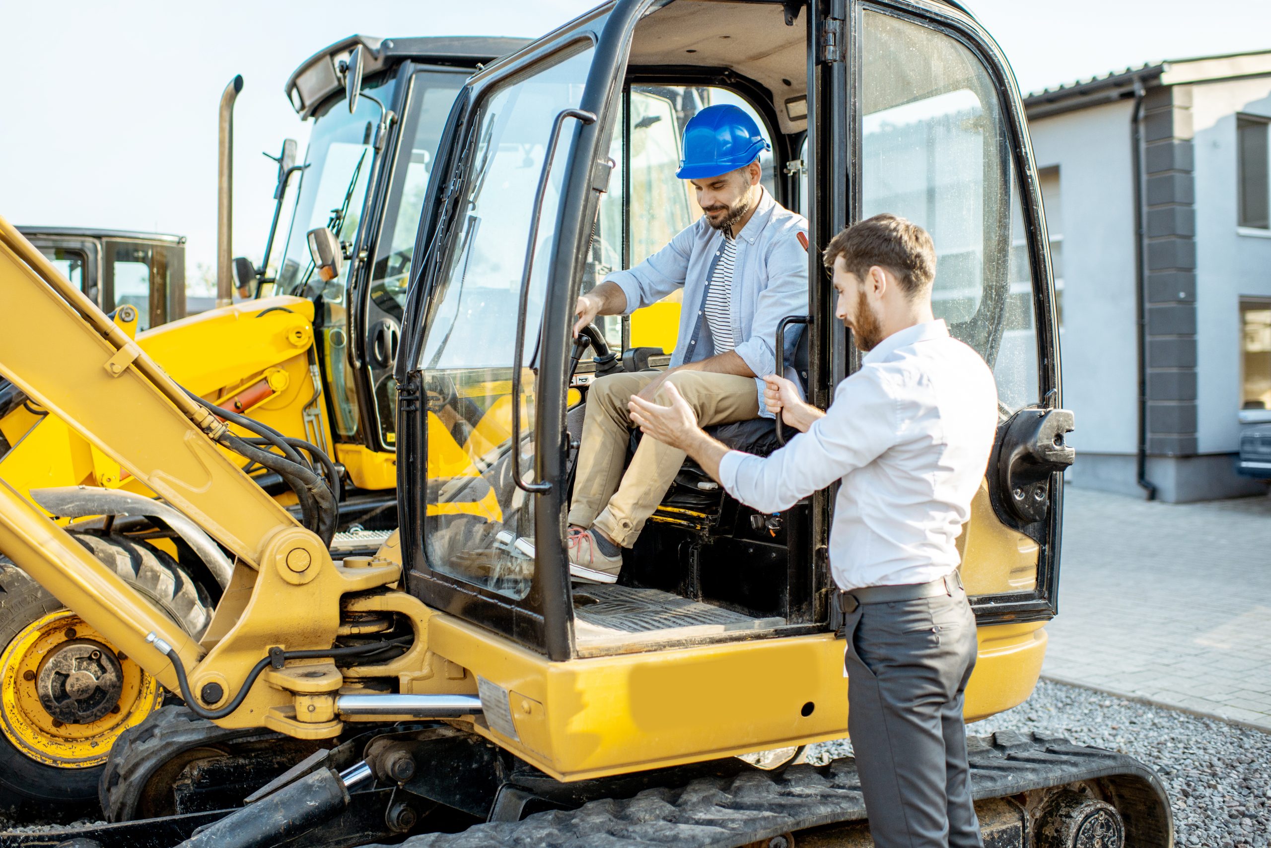 builder with a sales consultant at the shop with heavy machinery