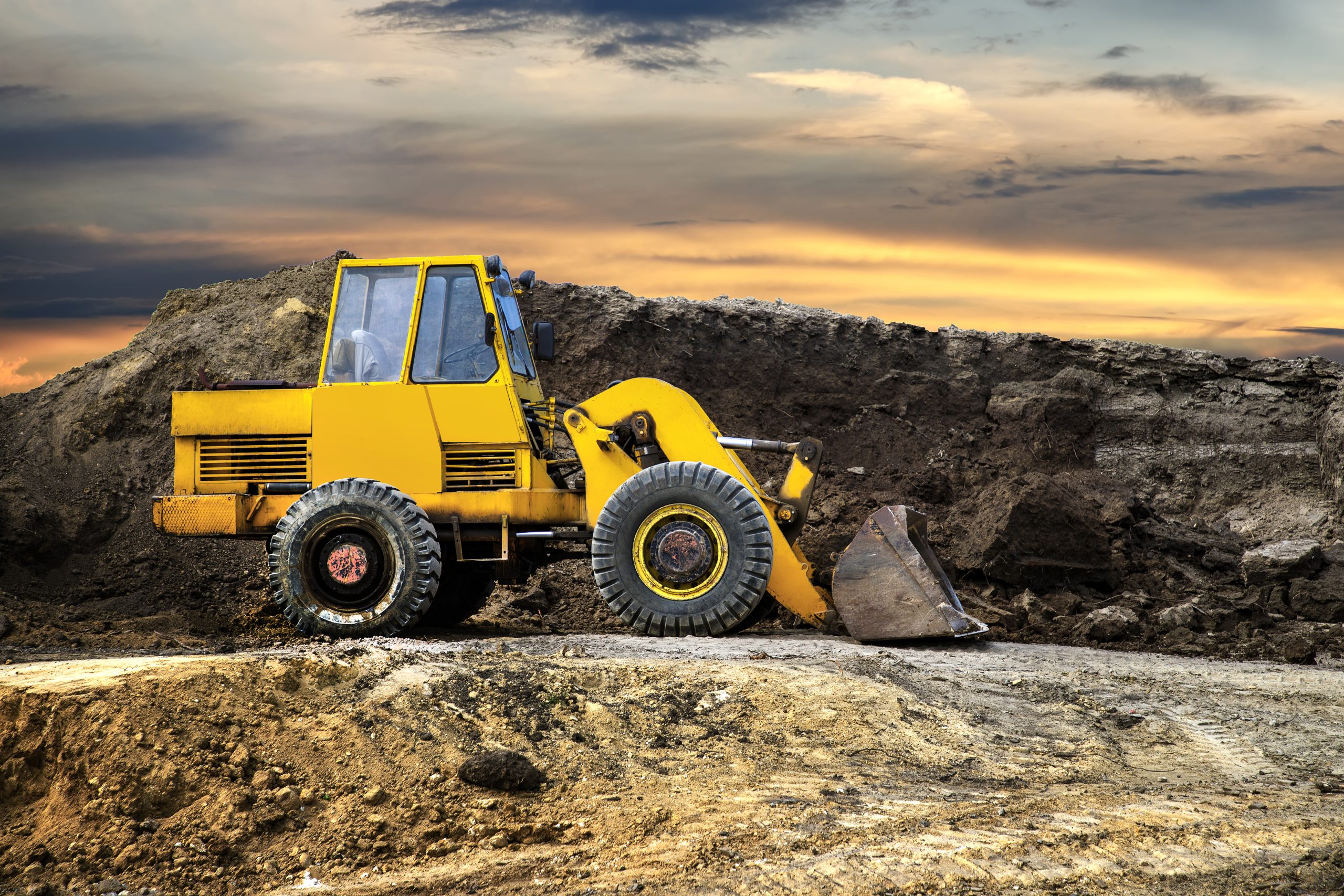 a bulldozer or loader moves the earth at the construction site a